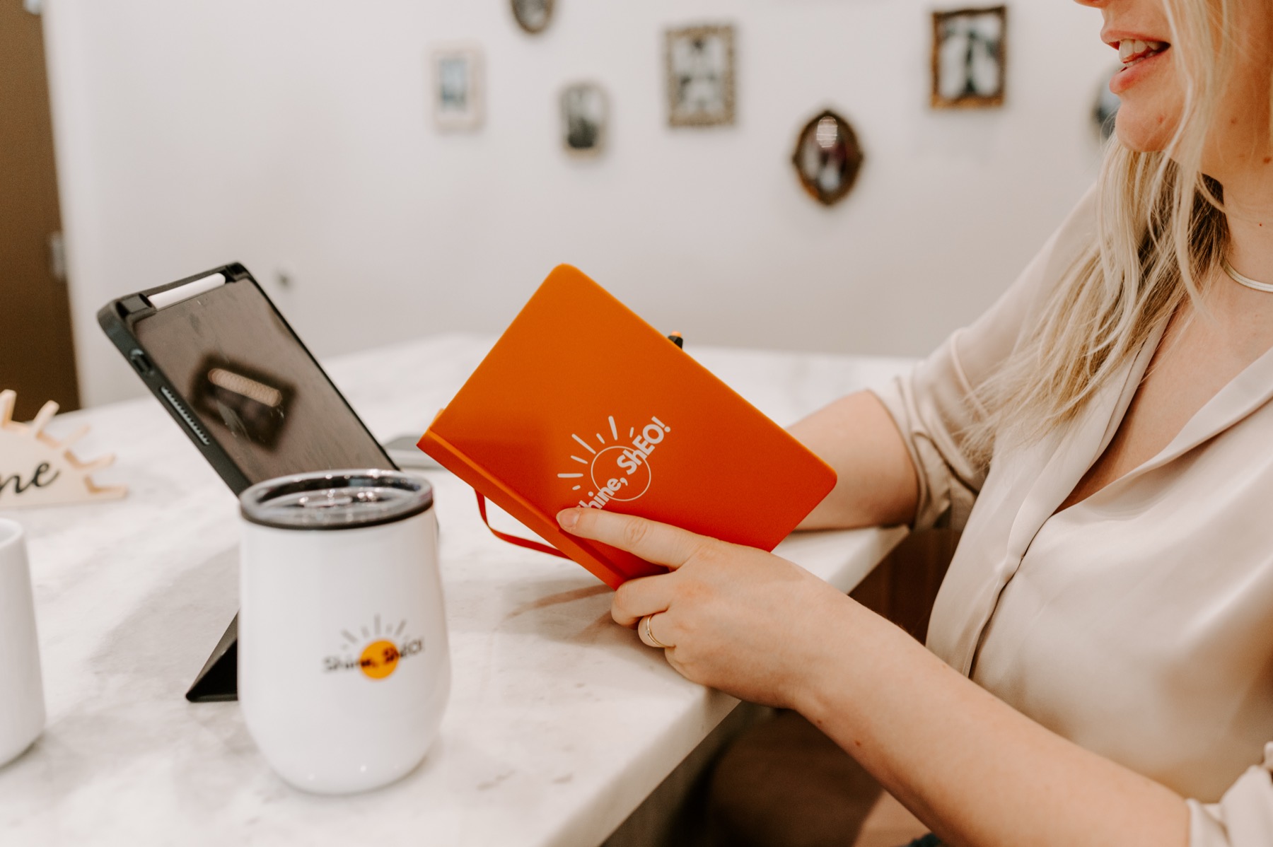 Sarah writing in her ShEO notebook over coffee